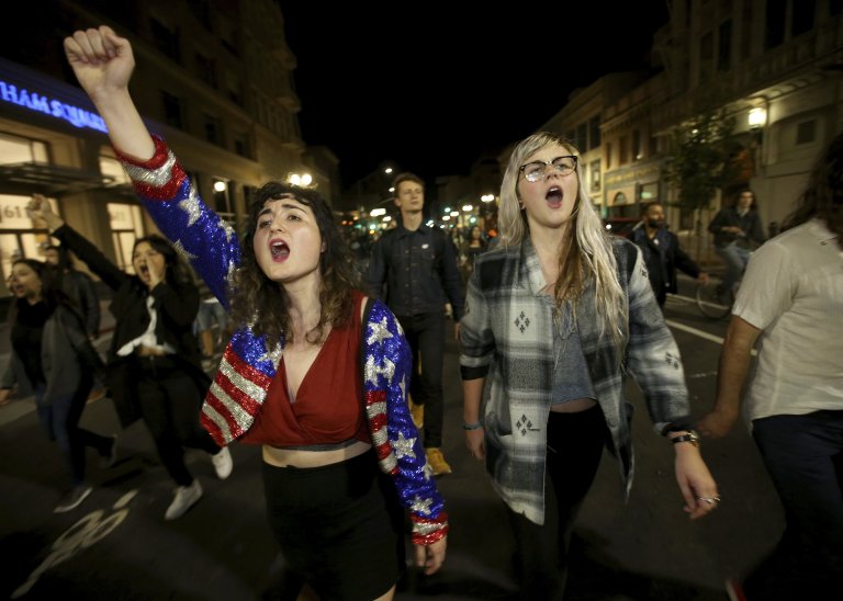Madeline Lopes, left, and Cassidy Irwin, both of Oakland, march with other protesters in downtown Oakland, Calif., early Wednesday, Nov. 9, 2016. President-elect Donald Trumpís victory set off multiple protests. (Jane Tyska/Bay Area News Group via AP)