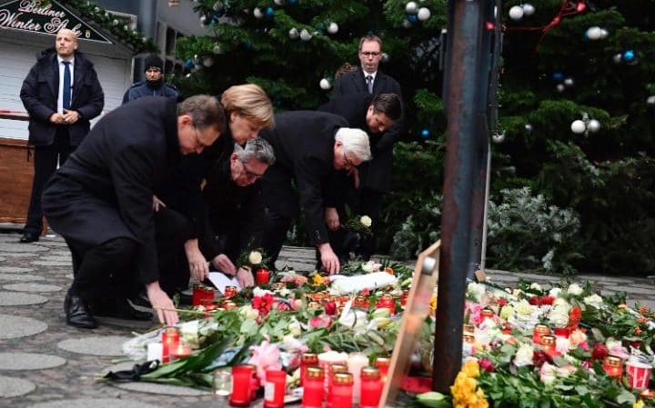  (L-R) Mayor of Berlin, Michael Muller, German Chancellor Angela Merkel, German Interior Minister Thomas de Maiziere and Interior Senator, Andreas Geisel pay there respects Credit: Getty 
