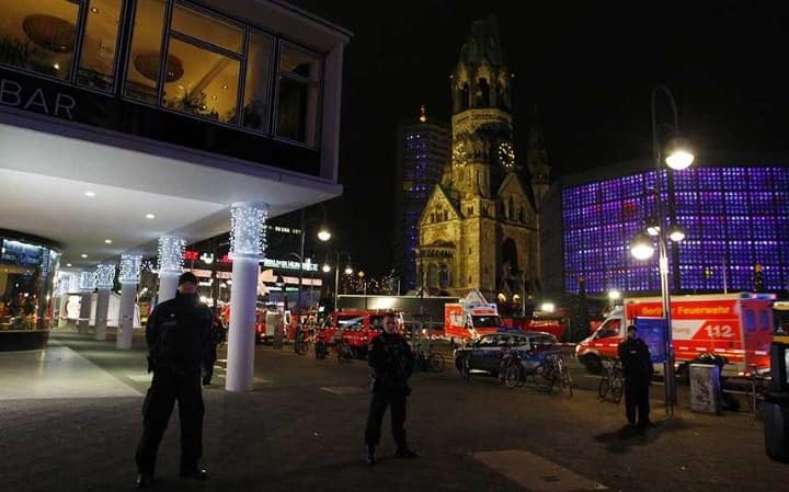 Security and rescue workers tend to the area after a lorry truck was ploughed through a Christmas market in Berlin Credit: Getty Images 
